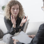 Stressed woman reviewing case with attorney